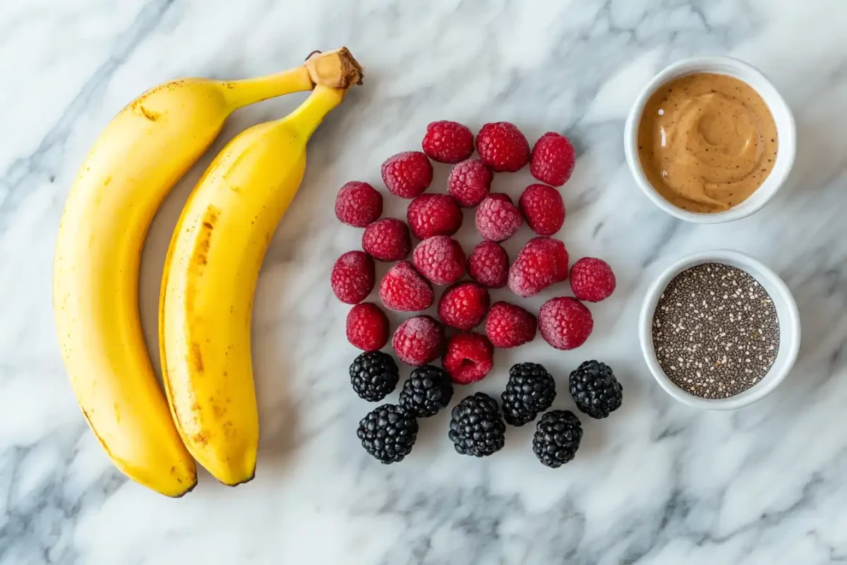 Flat lay of smoothie ingredients including banana, berries, and chia
