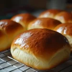 golden brioche loaf resting on cooling rack