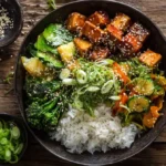 Overhead shot of gochujang tofu rice bowl with tofu and vegetables