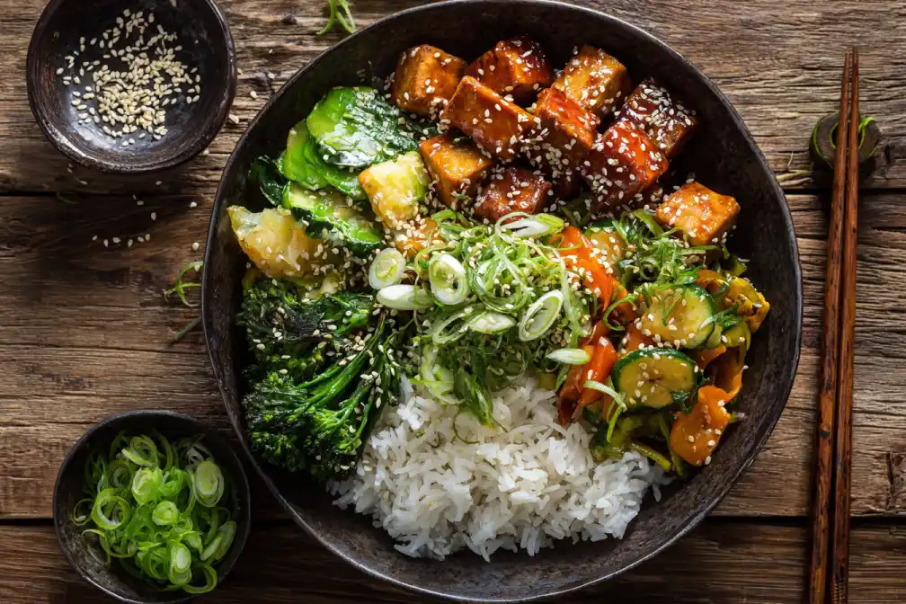 Overhead shot of gochujang tofu rice bowl with tofu and vegetables