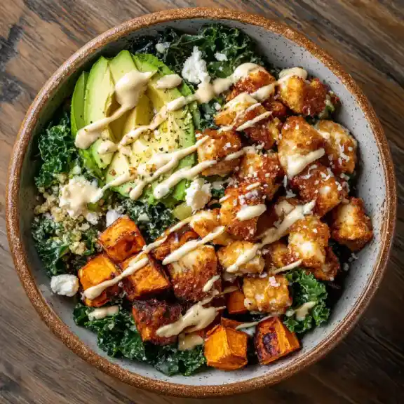 Crispy Chicken & Roasted Sweet Potato Bowl with chipotle sauce and avocado