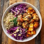 healthy hot honey chicken bowl with quinoa and slaw