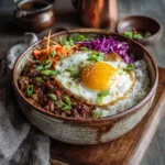 korean bbq beef bowl with rice, egg, and slaw