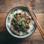 korean beef rice bowl recipe served with sesame seeds and scallions