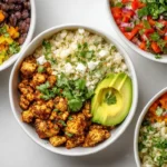 vegan burrito bowls with cauliflower rice in white bowl