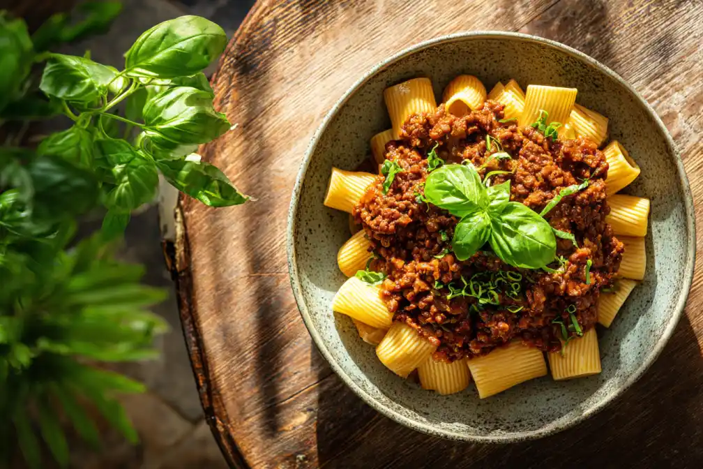 vegan lentil bolognese bowl served over rigatoni pasta