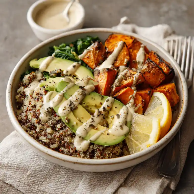 Served vegan grain bowl with creamy tahini dressing